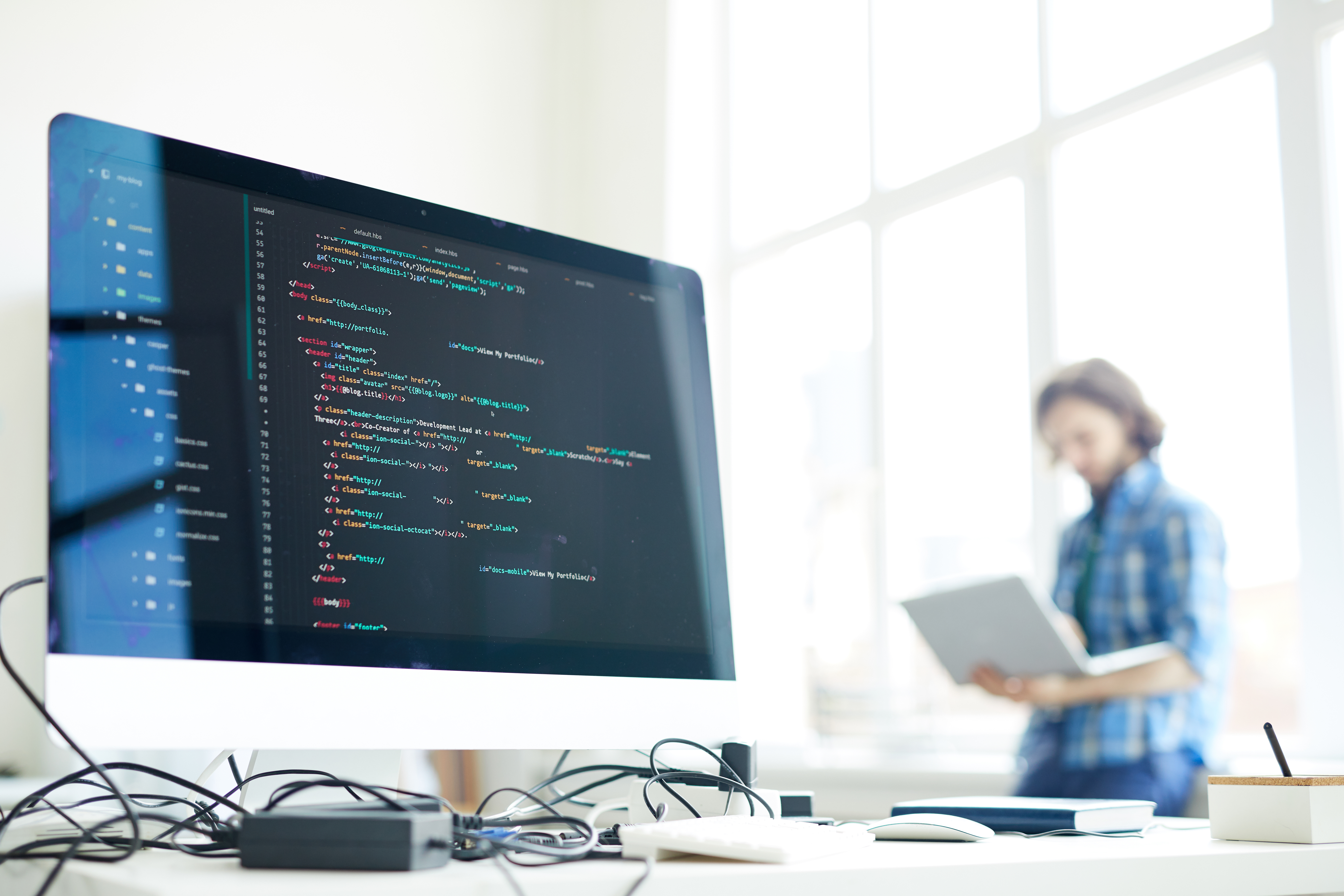 Coded data on computer screen at workplace of modern programmer networking on background