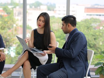 Businessman Giving Speech On Business Meeting With Colleagues, Discussing Work Ideas And Projects, Making Presentation Standing In Modern Office. Teamwork, Entrepreneurship, Corporate Meeting